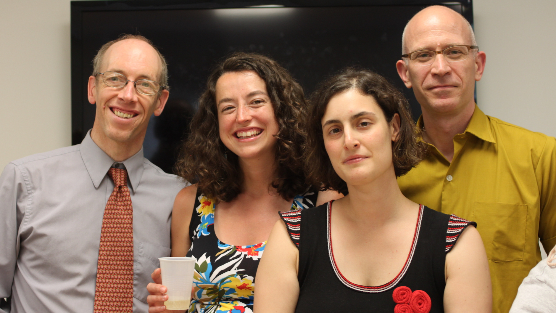 PhD student Sol Lago, facing the camera proudly, surrounded by her dissertation committee: Colin Phillips, Ellen Lau and Alexander Williams