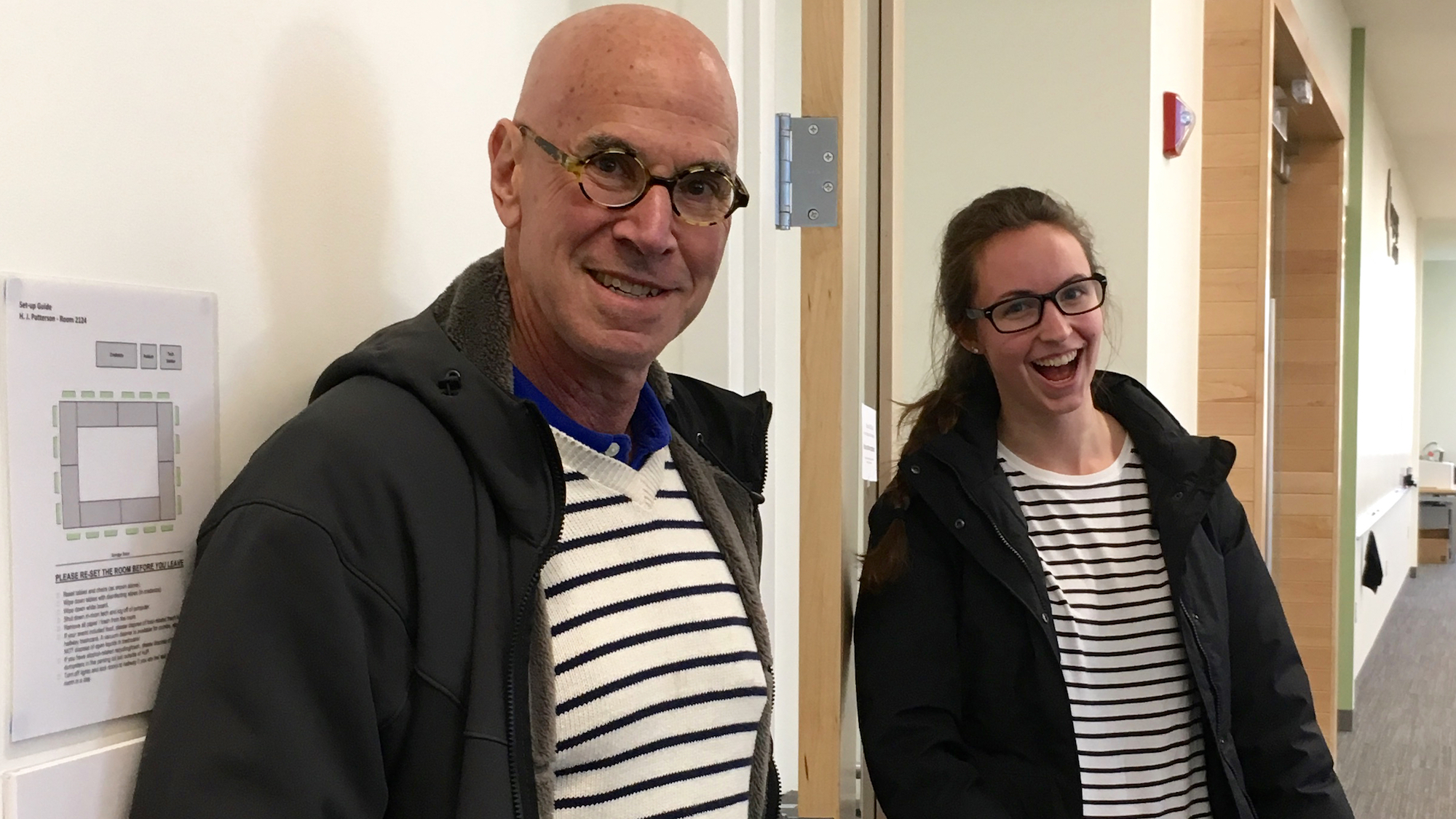 Professor Norbert Hornstein and PhD Student Hanna Muller, both wearing French stripes and laughing bemusedly at the camera