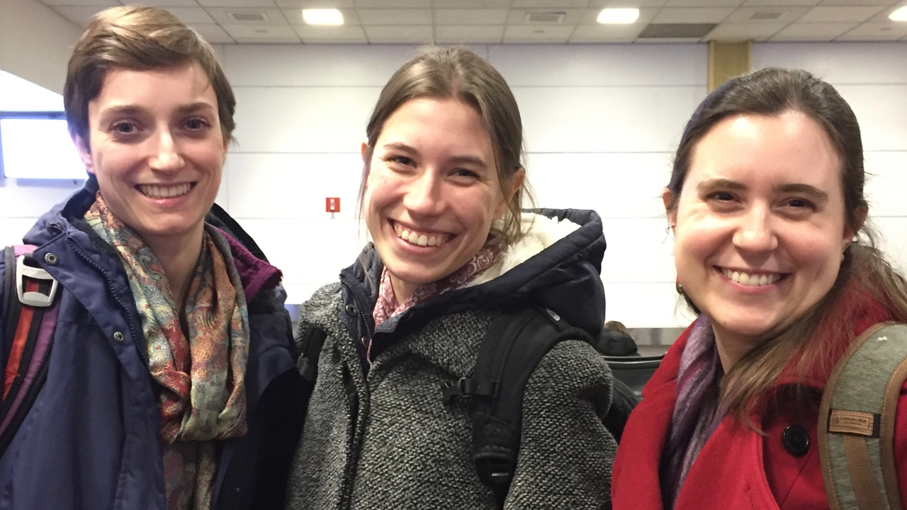 Three young women standing together, smiling at the camera: Linguistics PhD students Lara Ehrenhofer, Kasia Hitczenko and Laurel Perkins
