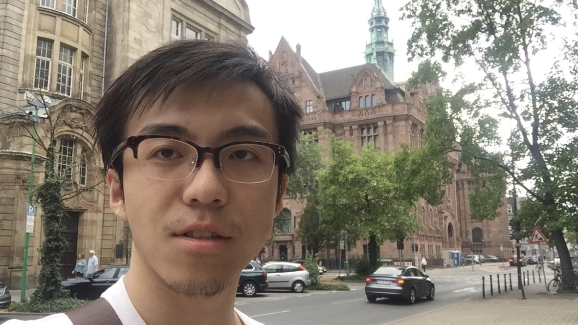 Linguistics PhD student Xinchi Yu standing on the street in Germany