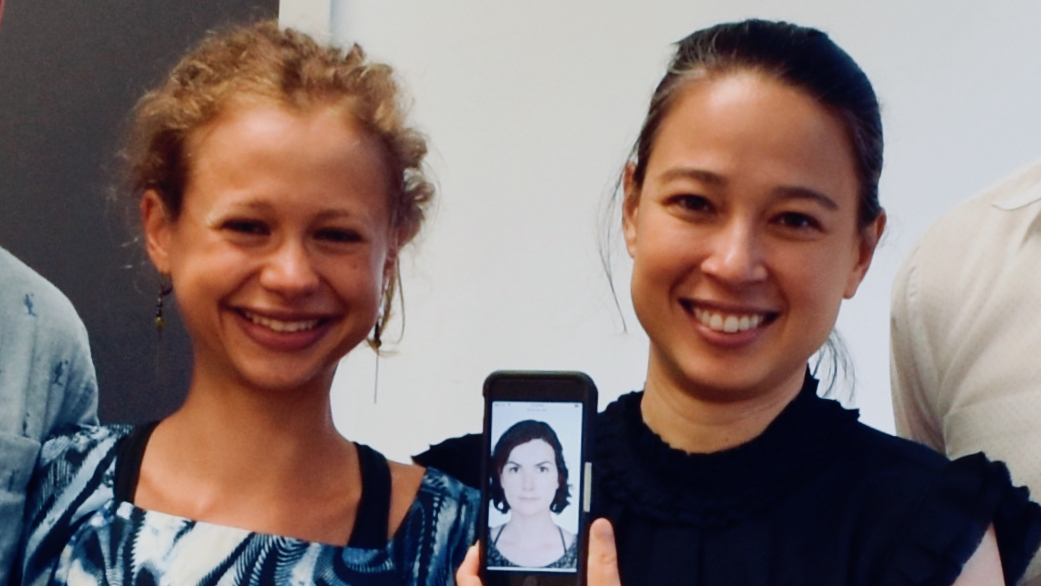 A portrait PhD student Anouk Dieuleveut with her advisor Valentine Hacquard, two faces smiling widely at the camera while Professor Hacquard holds up an iPhone to show outside advisor Ailis Cournane joining by phone