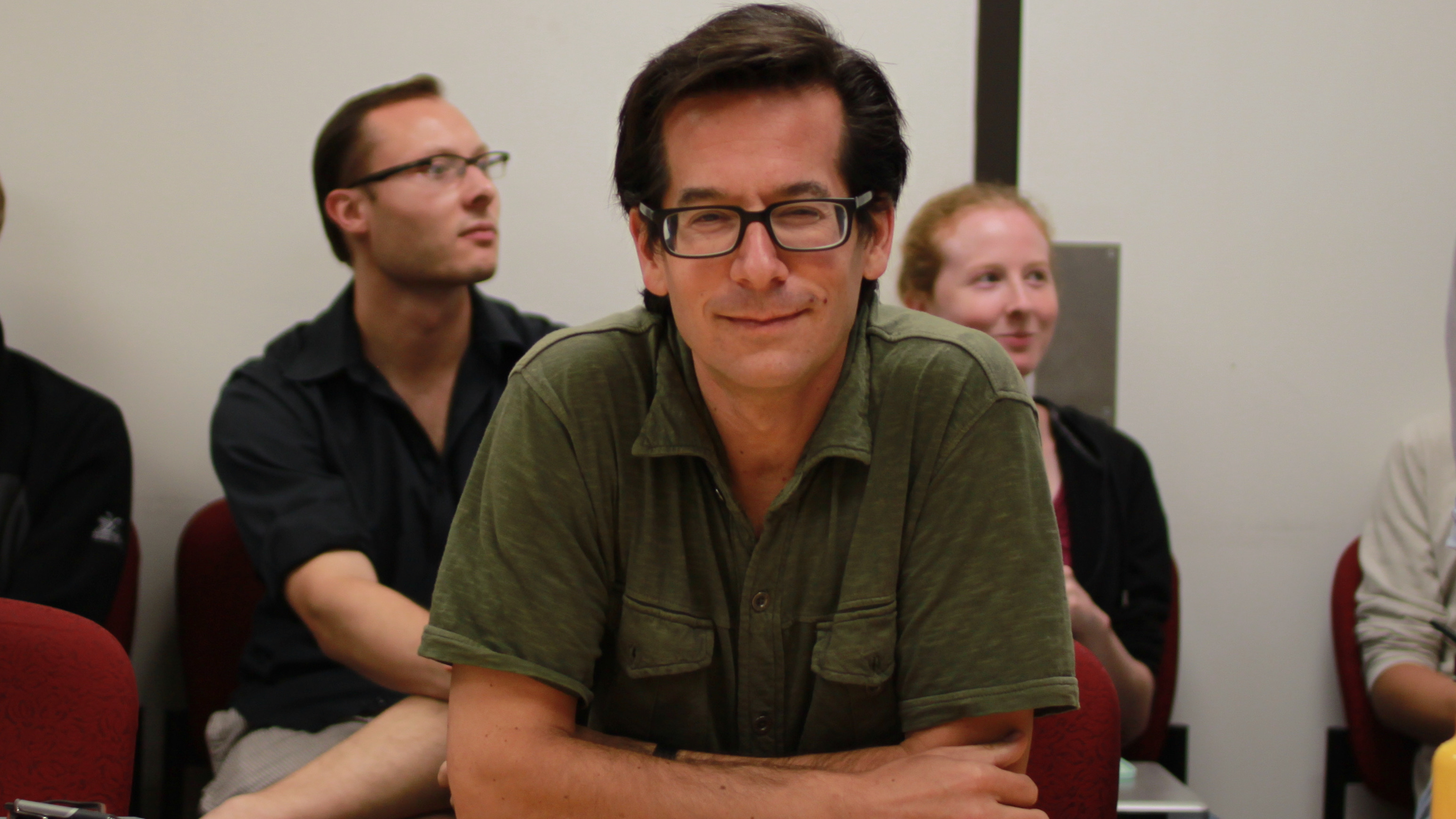 Linguistics faculty Jeff Lidz sitting at a meeting and looking skeptically at the camera, with humor.