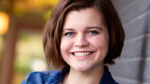 Portrait of a young woman smiling at the camera.