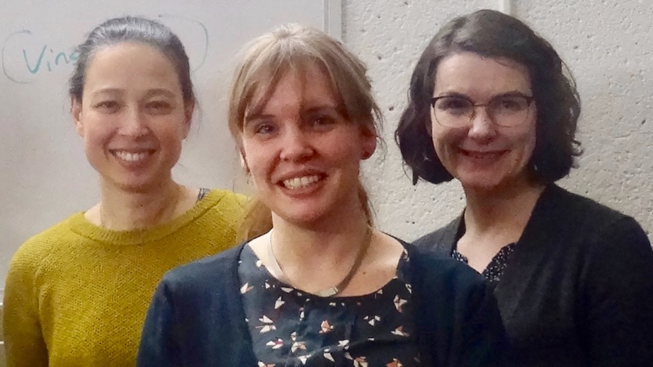 Annemarie van Dooren, PhD student in Linguisitcs, flanked by two faculty advisors, Valentine Hacquard and Ailïs Cournane, all smiling at the camera after a successful qualifying defense.