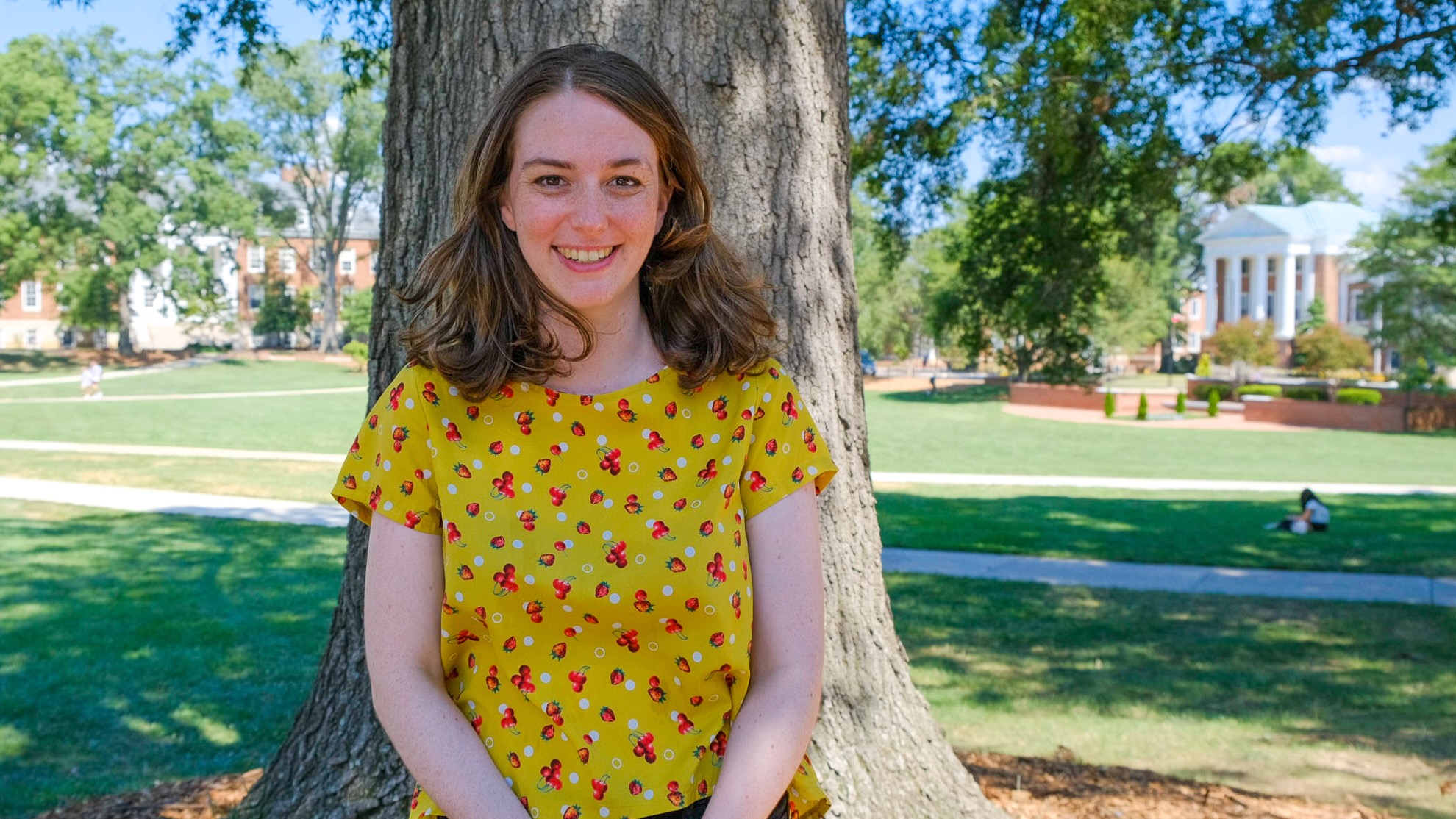 Allison Dods, PhD student in Linguistics, standing outside on McKeldin Mall in the sun.