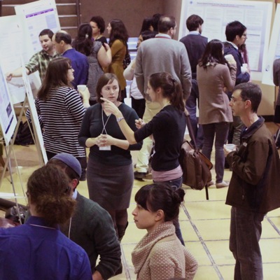 A group of graduate students presenting research using posters.