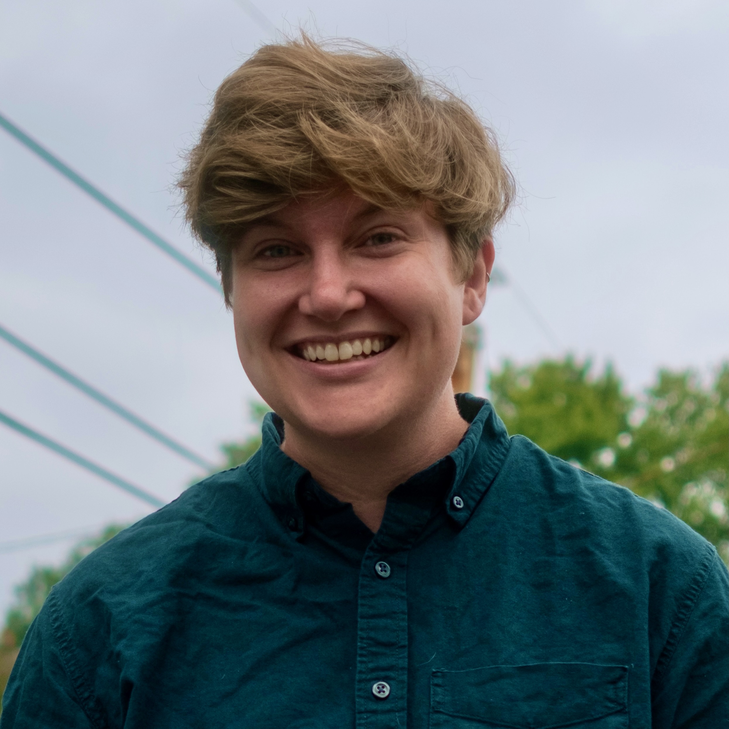 Headshot of a young woman outside.