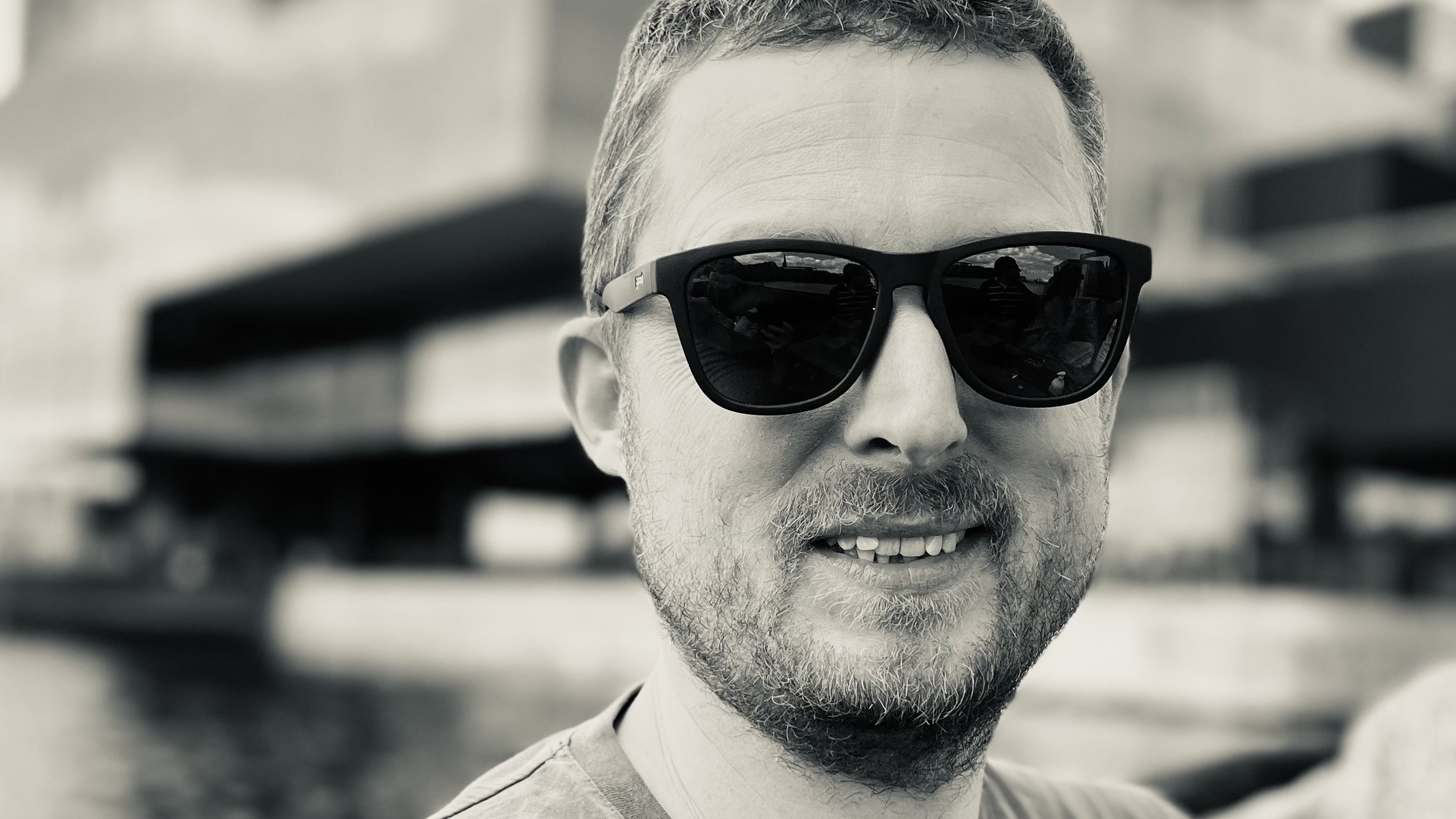 Black and white portrait of a man wearing sunglasses.