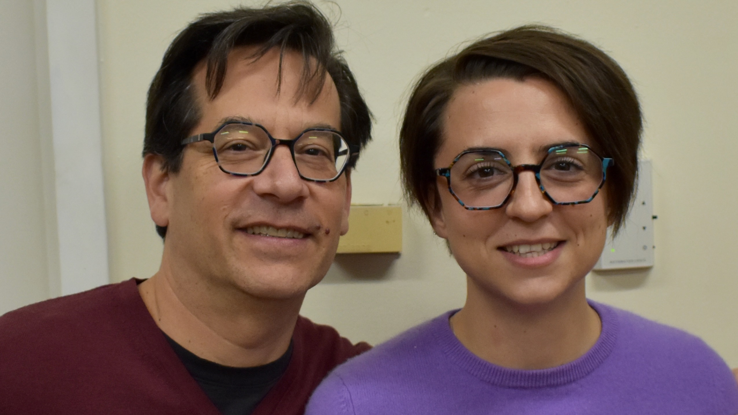 A man and a woman, wearing very similar glasses, one hexagonal and the other heptagonal.