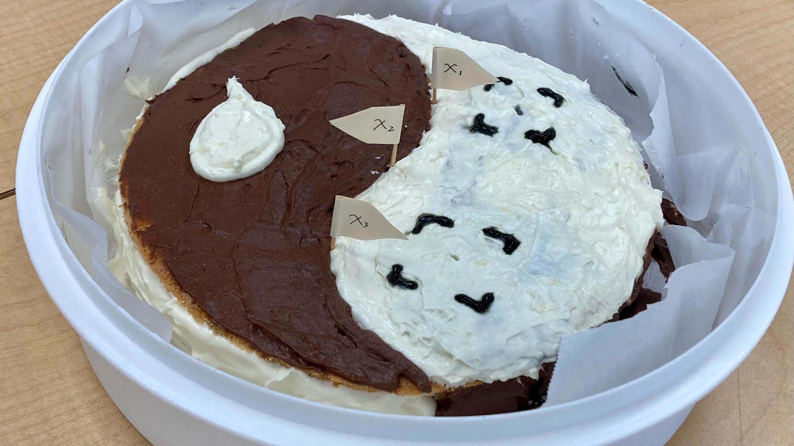 A cake whose frosting makes a ying-yang symbol.