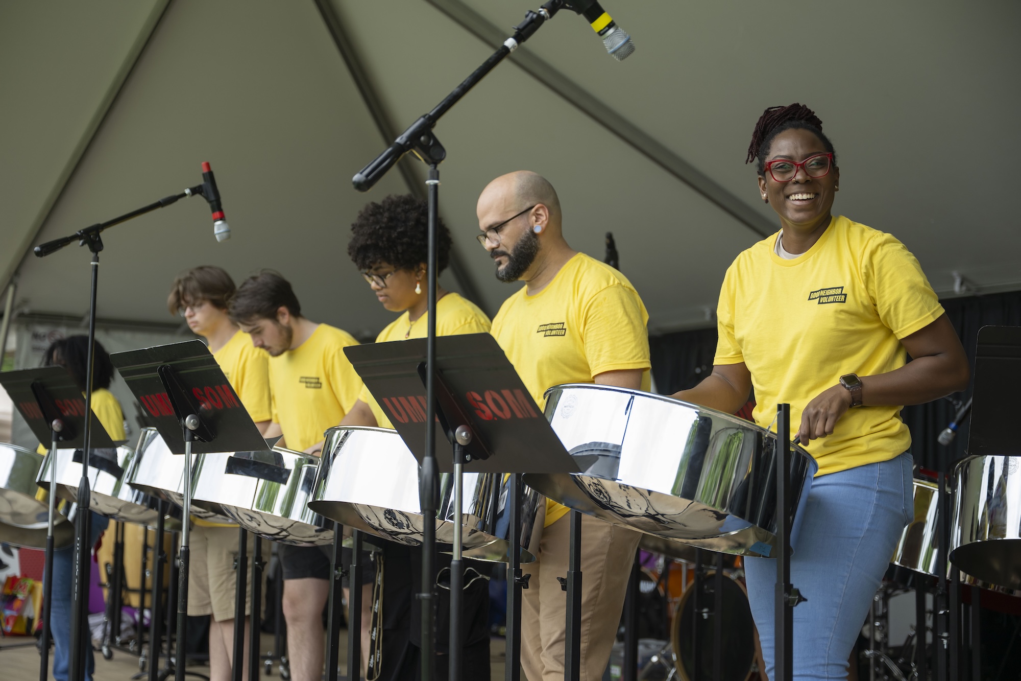 Josanne Francis and members of her steelband ensemble perform on stage.