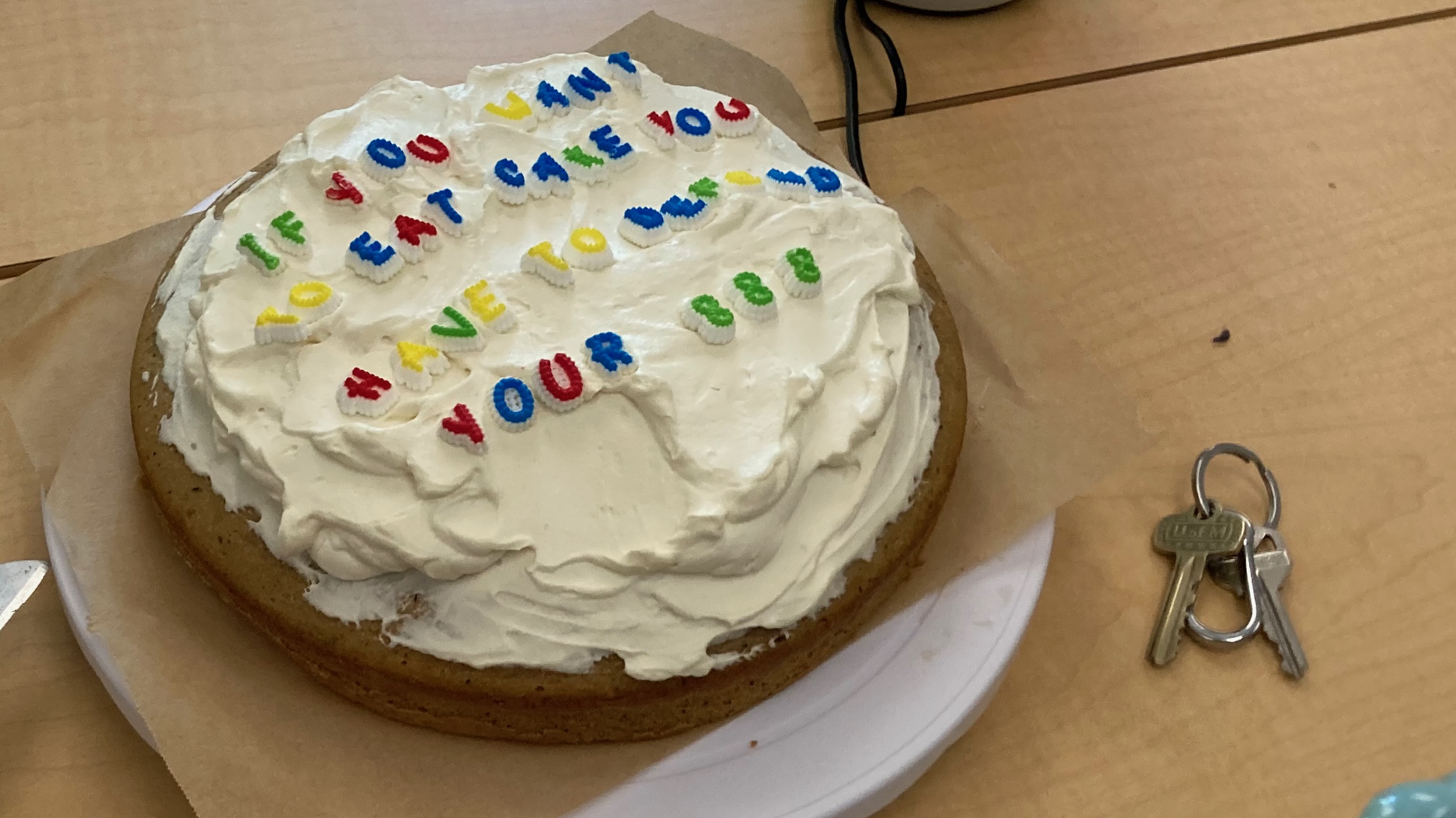 A frosted cake, and written on top in candy letters: "If you want to eat cake you have to defend your 888."