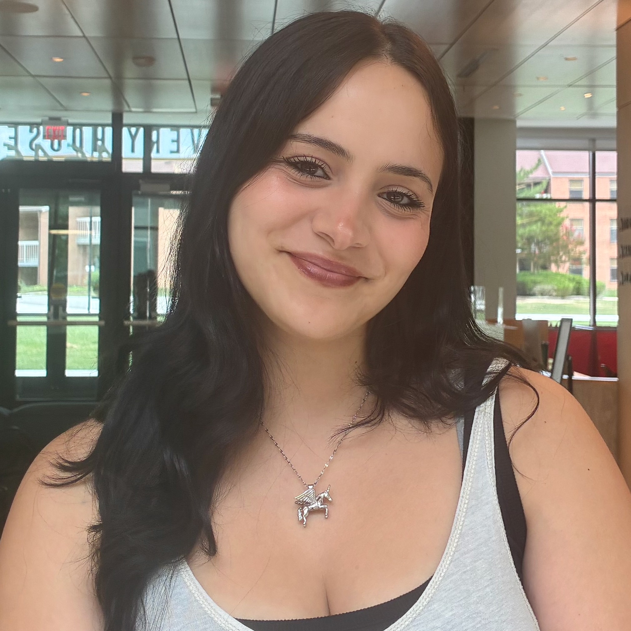 Portrait of a young woman, smiling at the camera.