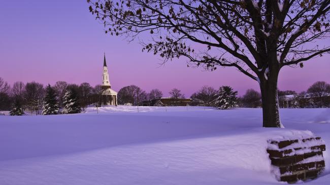 Marie Mount Hall, after a heavy snowfall, bathed in the purple light of dawn